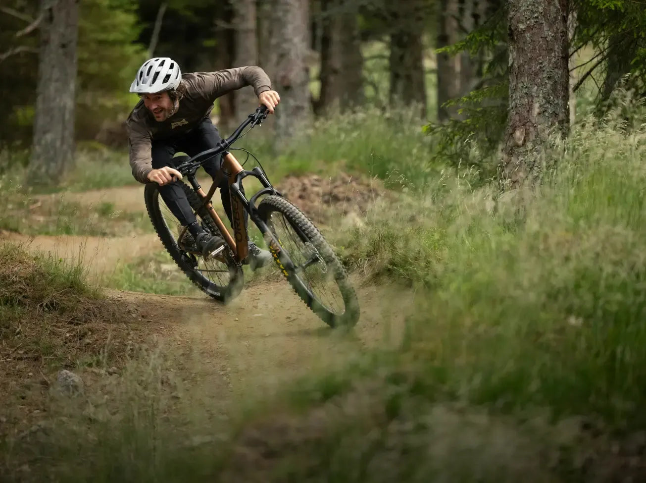 Person riding a mountain bike on a trail in a forest