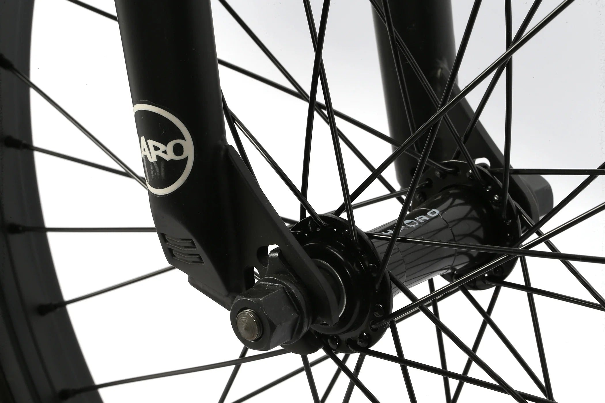 Close-up of a BMX bicycle wheel with a brand logo on the hub