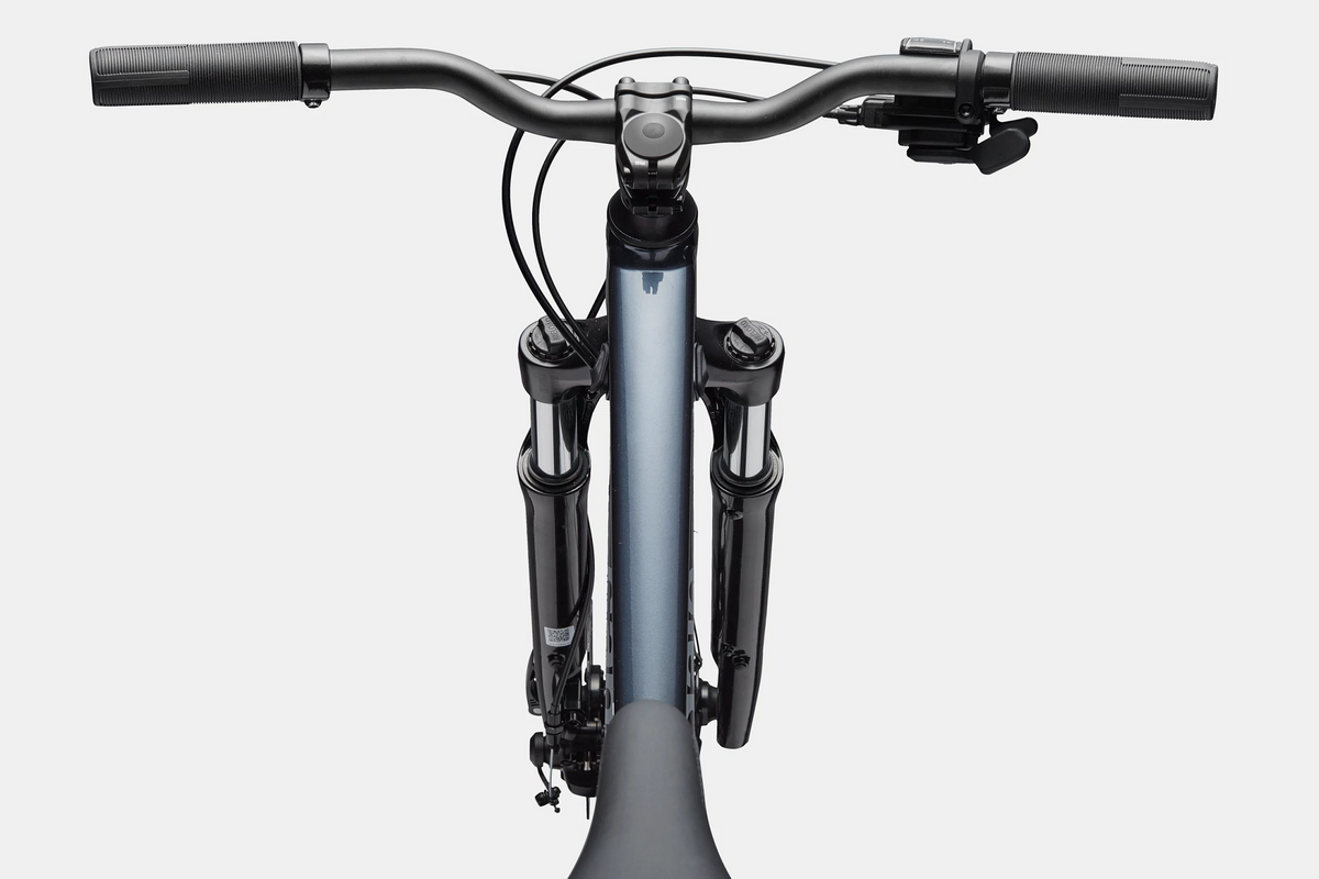 Close up of the handlebar and top tube of a steel blue mountain bike on a white background