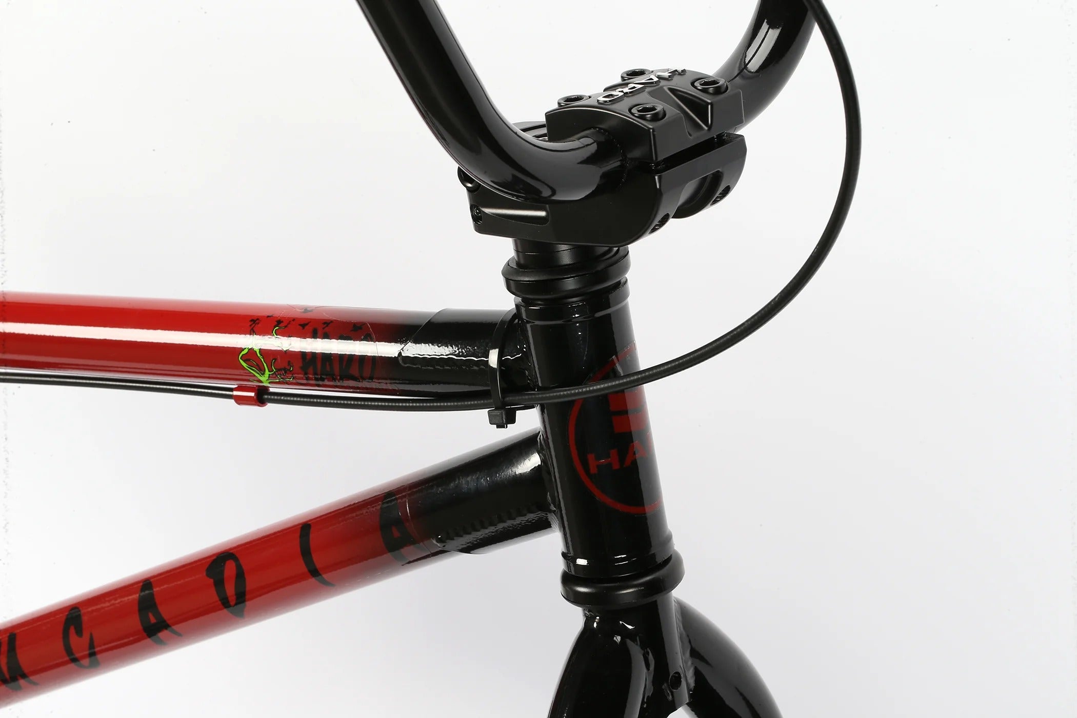 Close-up of a BMX frame with red and black design on a white background