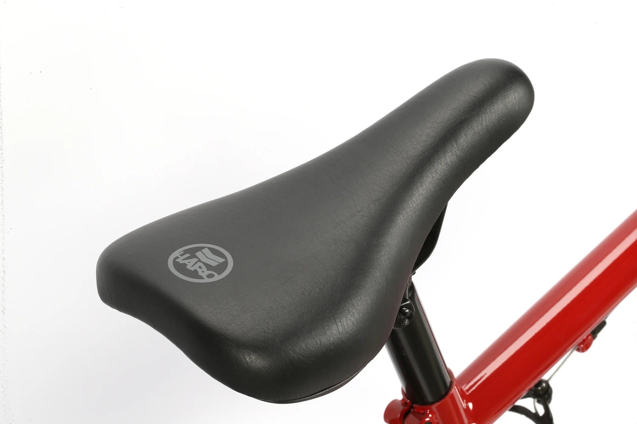 Close-up of a black Haro bmx bike seat with a visible brand logo on a white background