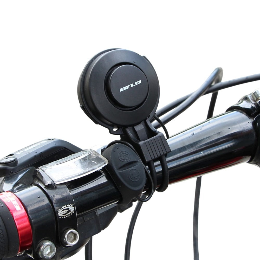 Bicycle handlebar with a black GUB bell and red accents on a white background