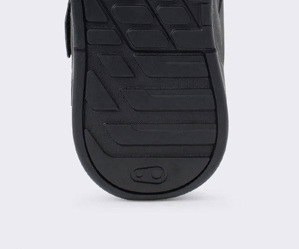 Close-up of a black mountain bike flat sole with textured pattern on a white background