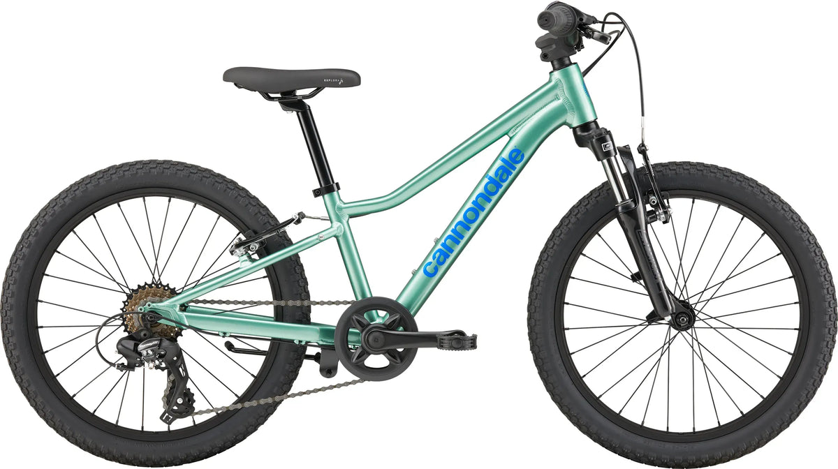 A green Cannondale kids mountain bike on a white background