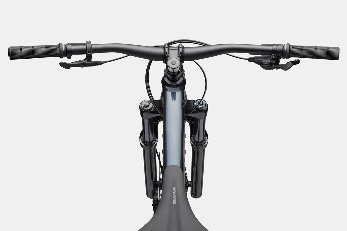 Close up of the handlebar and top tube of a blue mountain bike on a white background