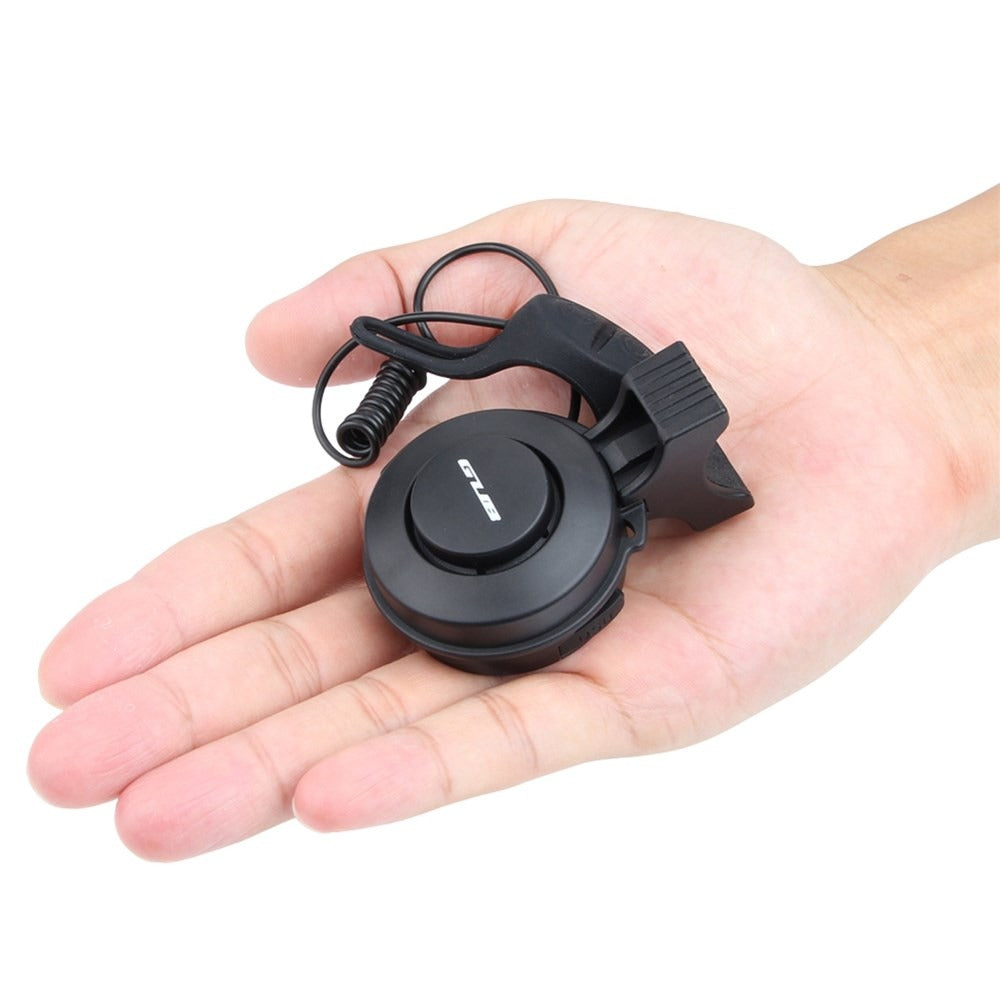Black GUB Electric Bicycle Bell held in a hand on a white background