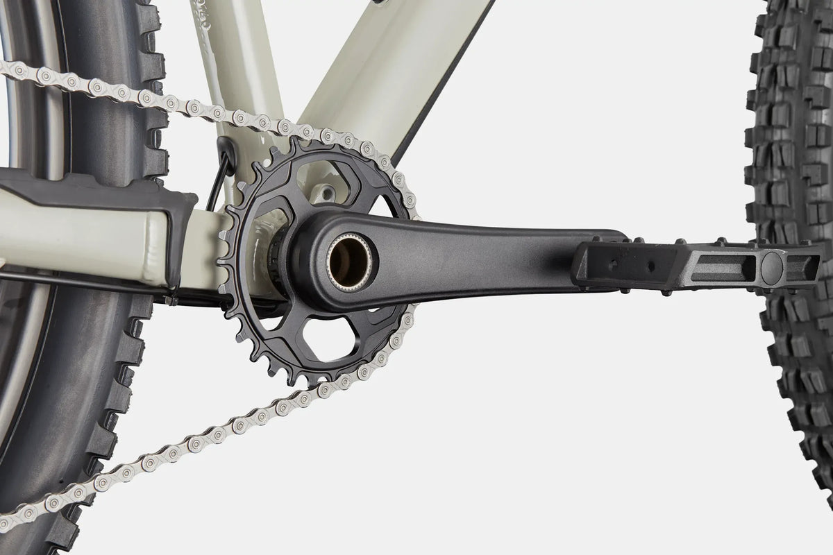 Close up of the front chainring on a grey mountain bike with a white background
