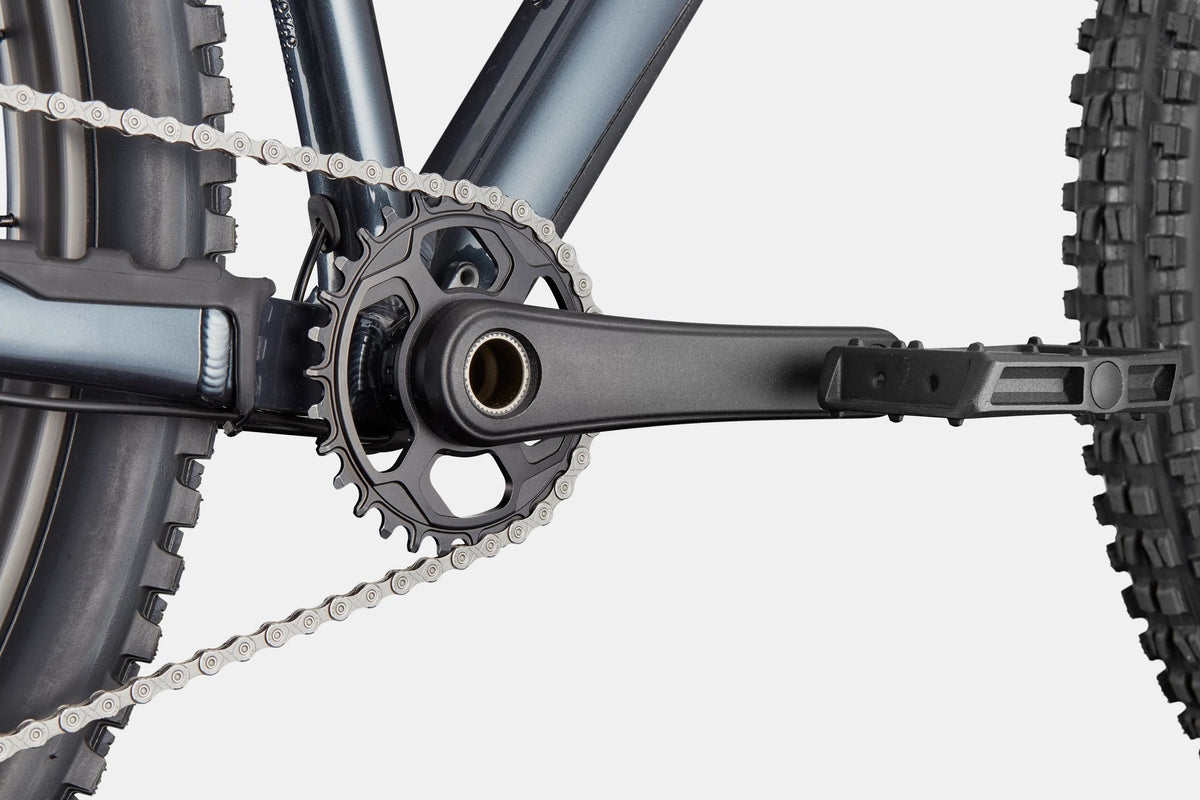 Close up of the front chainring on a blue mountain bike on a white background