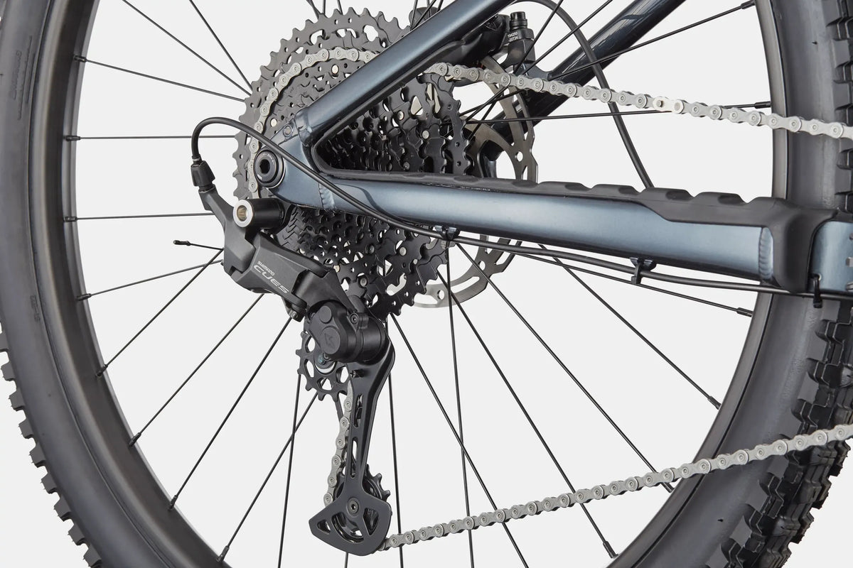 Close up of the rear casstte on a blue mountain bike on a white background