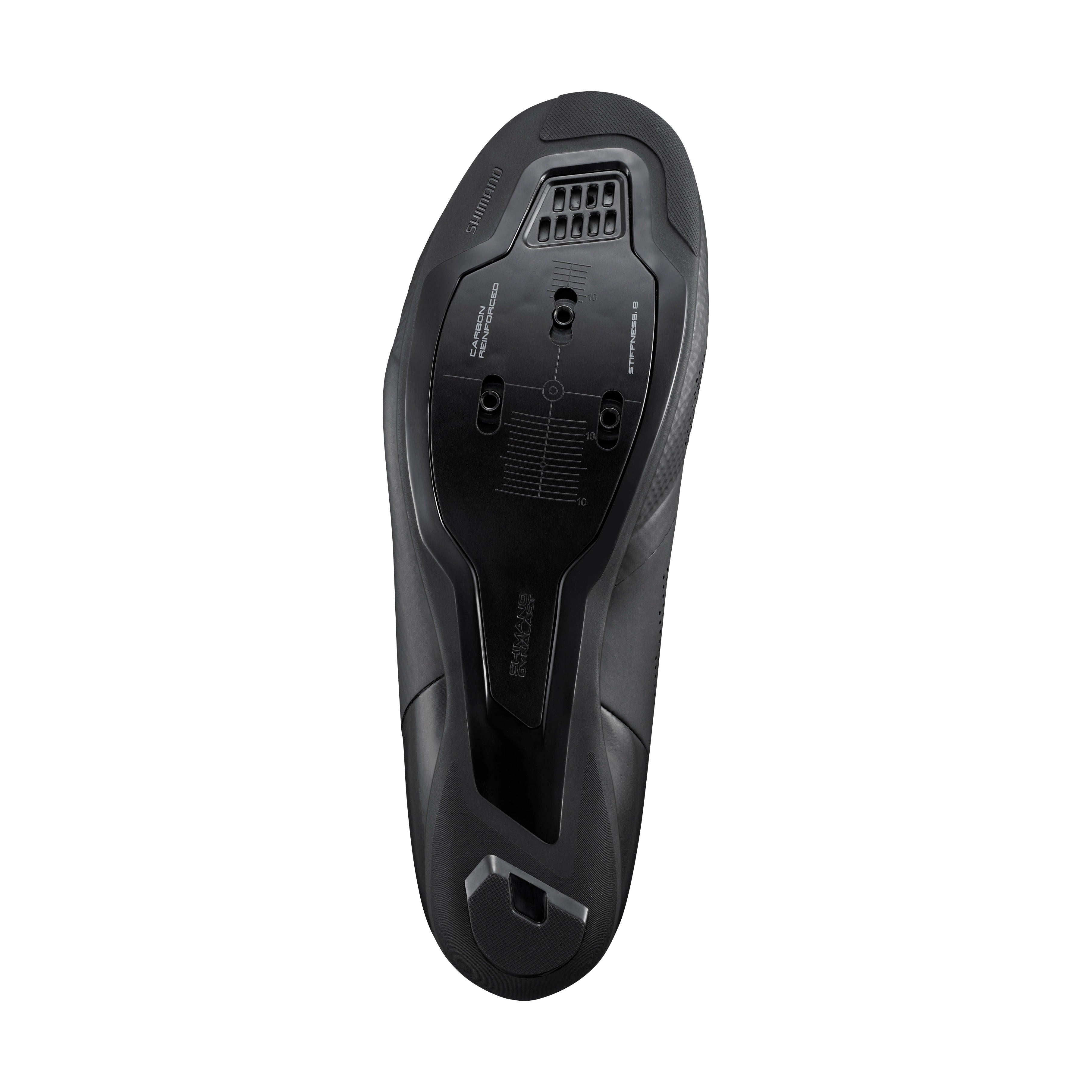 Black sole of a road bike shoe showing the cleat bolts against a white background