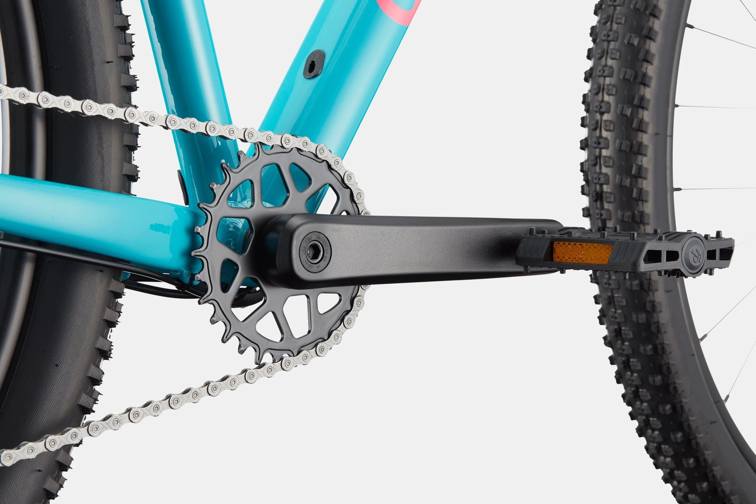 Close-up of a bicycle chain and gear system on a light gray background