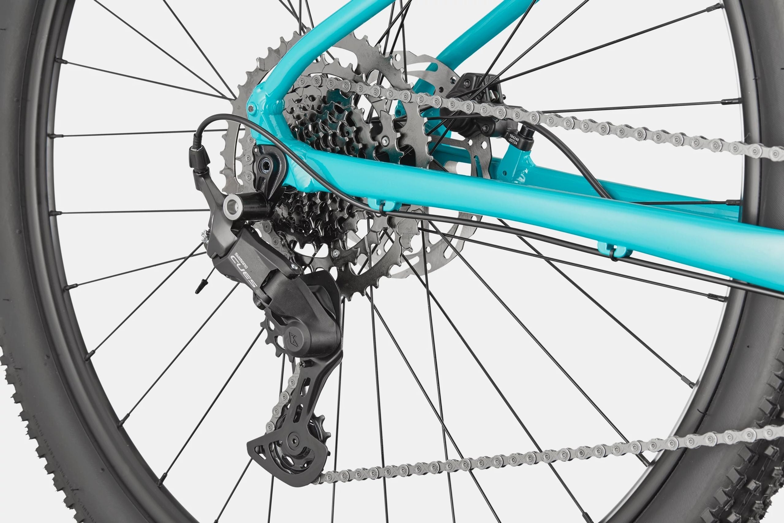 Close-up of a bicycle's gear system with a teal frame.