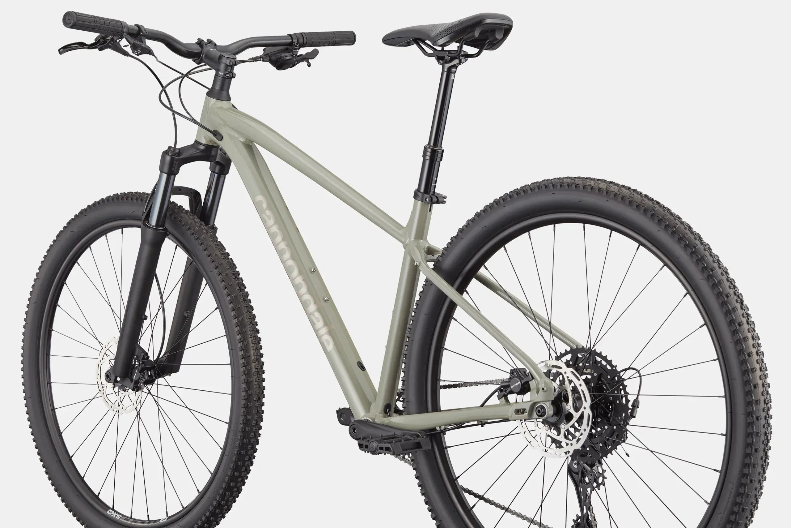Mountain bike with a light green frame and black components on a white background