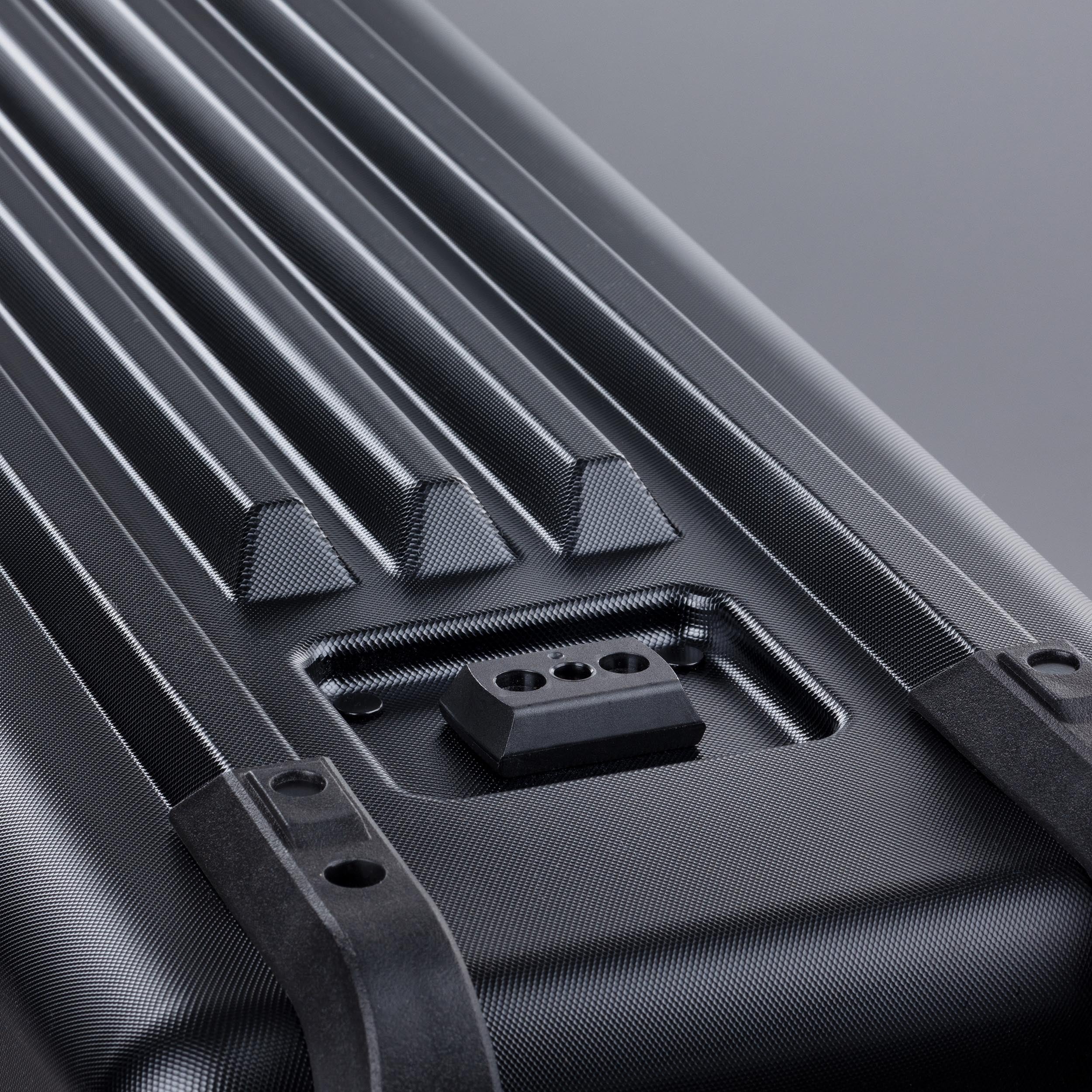 Close-up of a black bike travel bag with textured surface and visible stitching details.