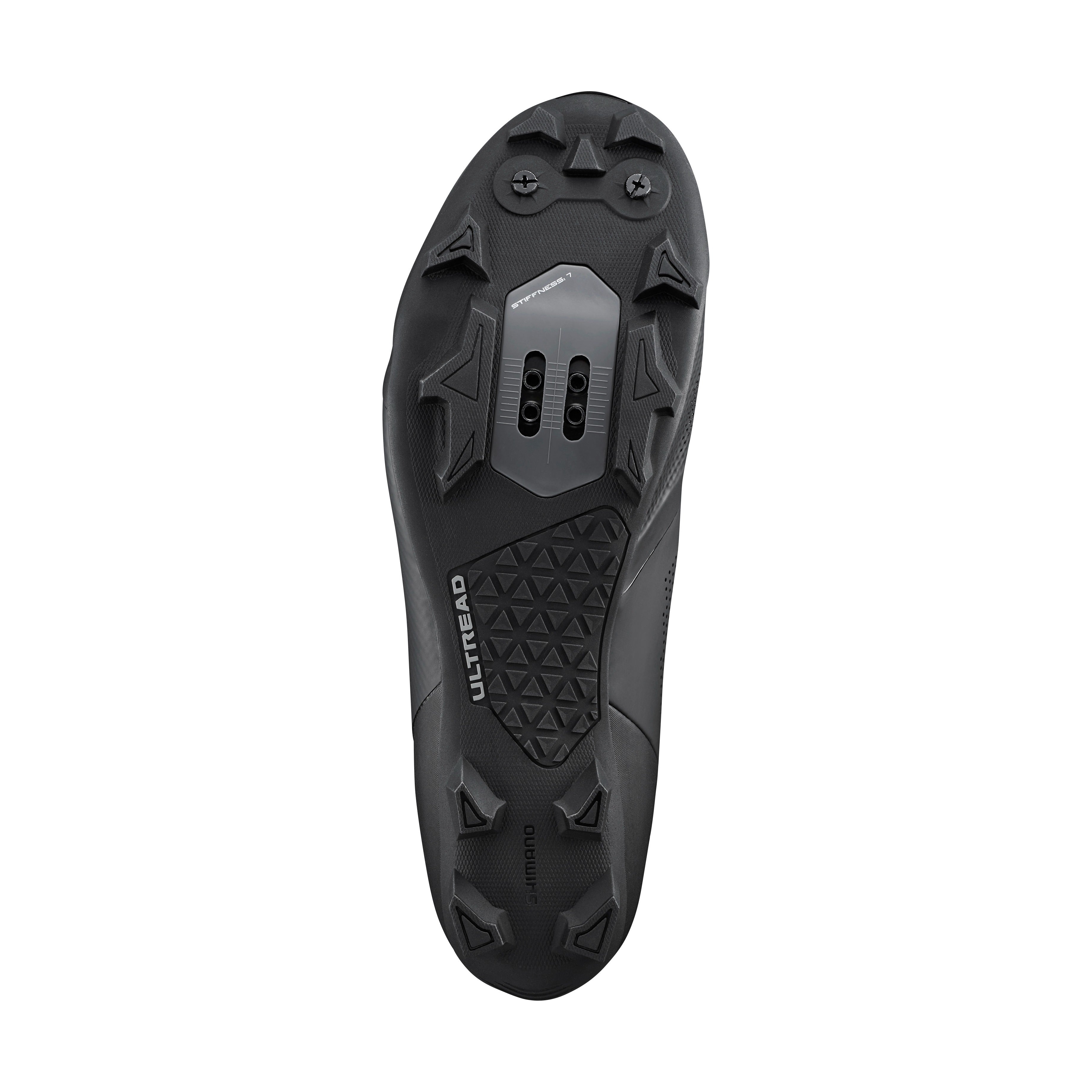 Black sole of a mountain bike shoe showing the cleat bolts on a white background