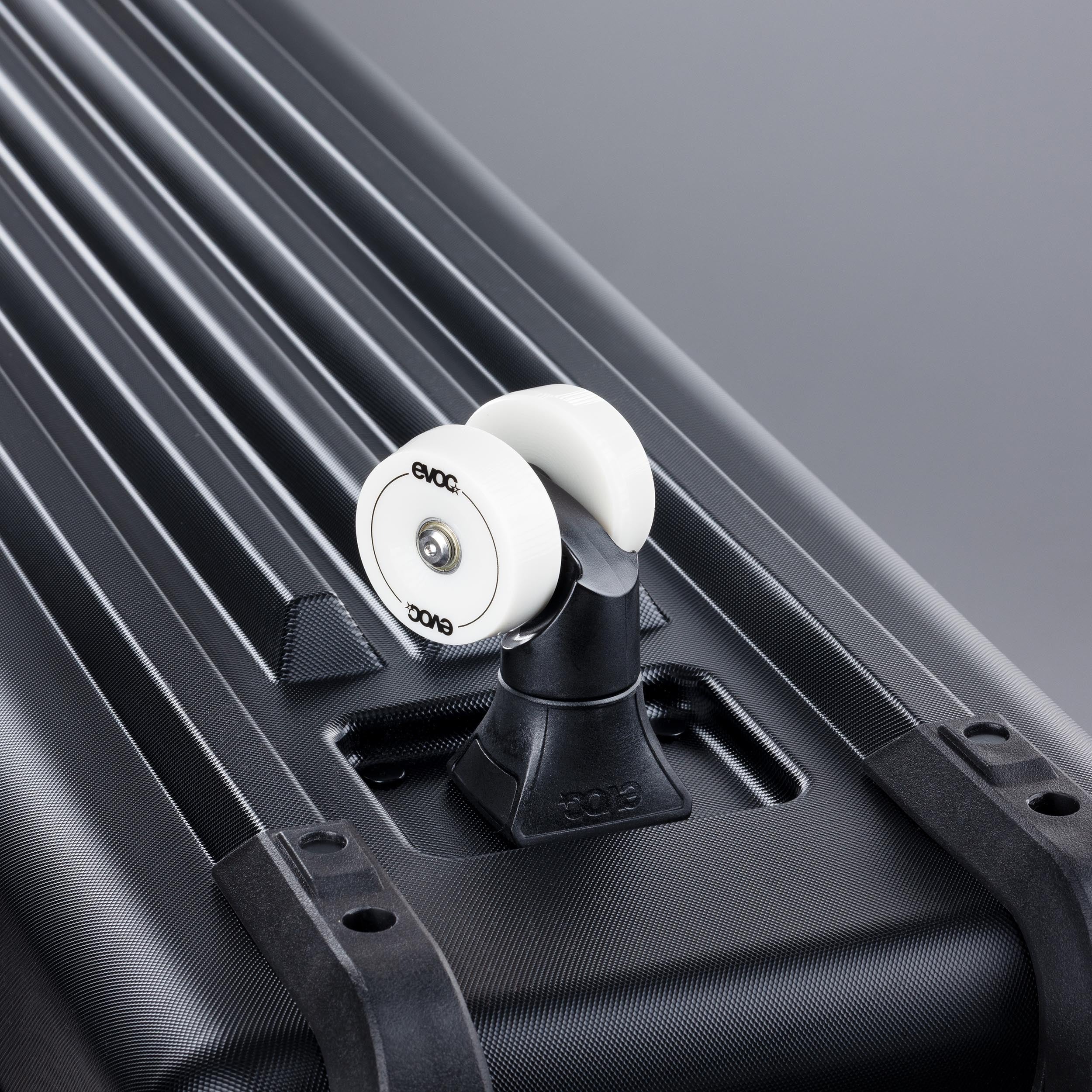 Close-up of the front wheel on an EVOC bike travel bag on a grey background