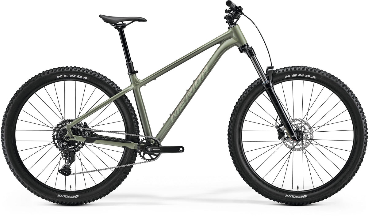 A green Merida hardtail mountain bike on a white background