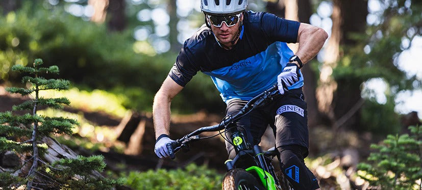 Man riding a mountain bike through a forest