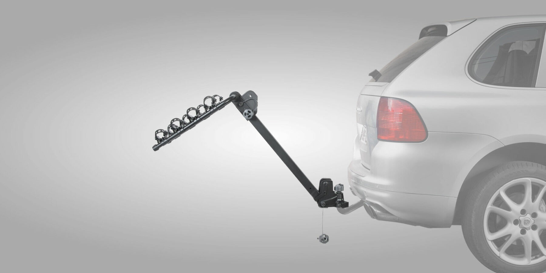Bike Rack on a car being tilted back to open the boot on a gray background
