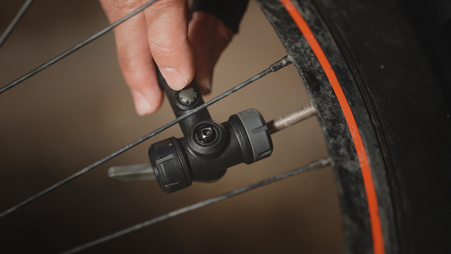 A close up of a smarthead from a Topeak floor pump being used to pump a tyre