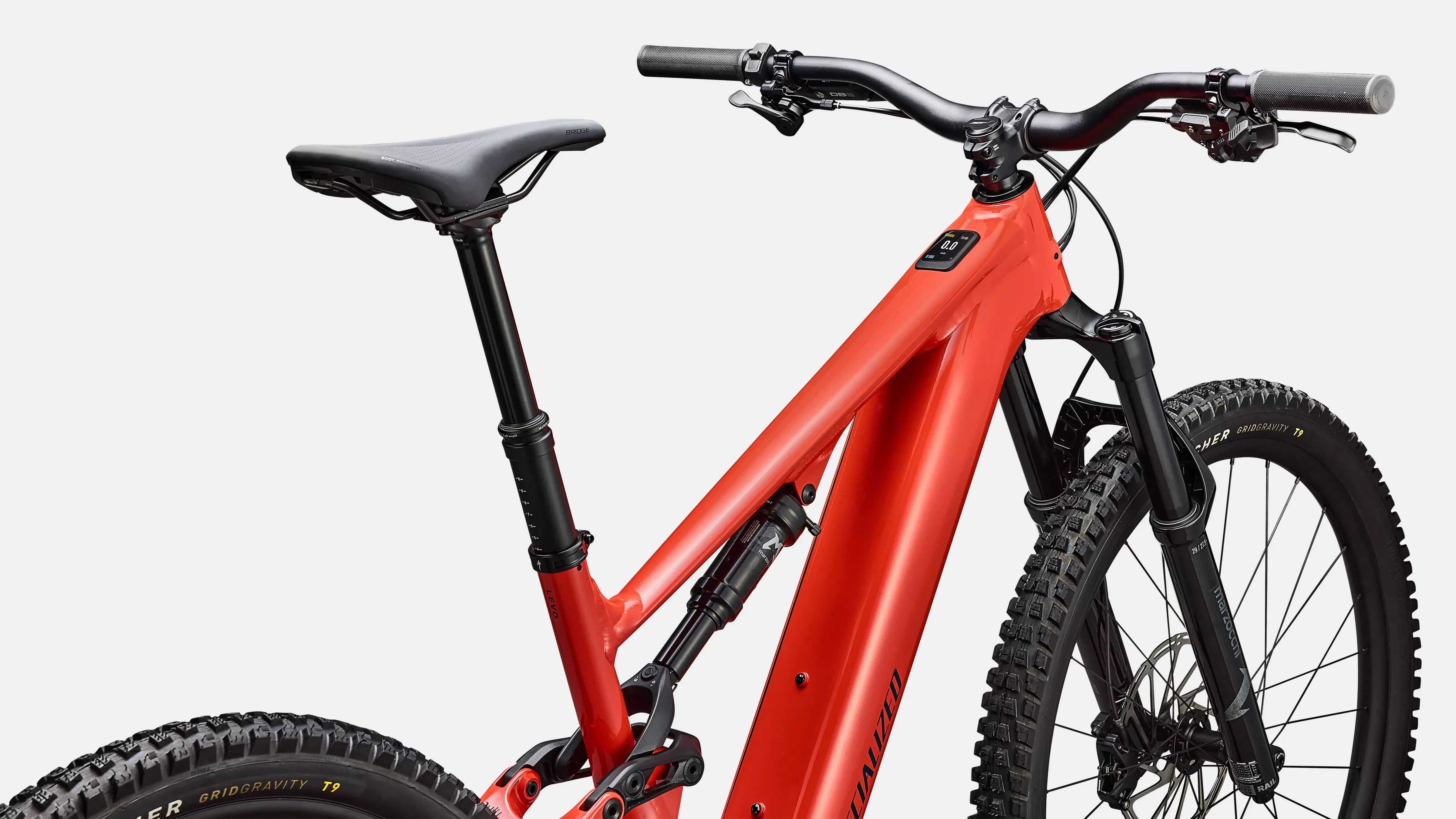 Red electric mountain bike with black components on a light gray background