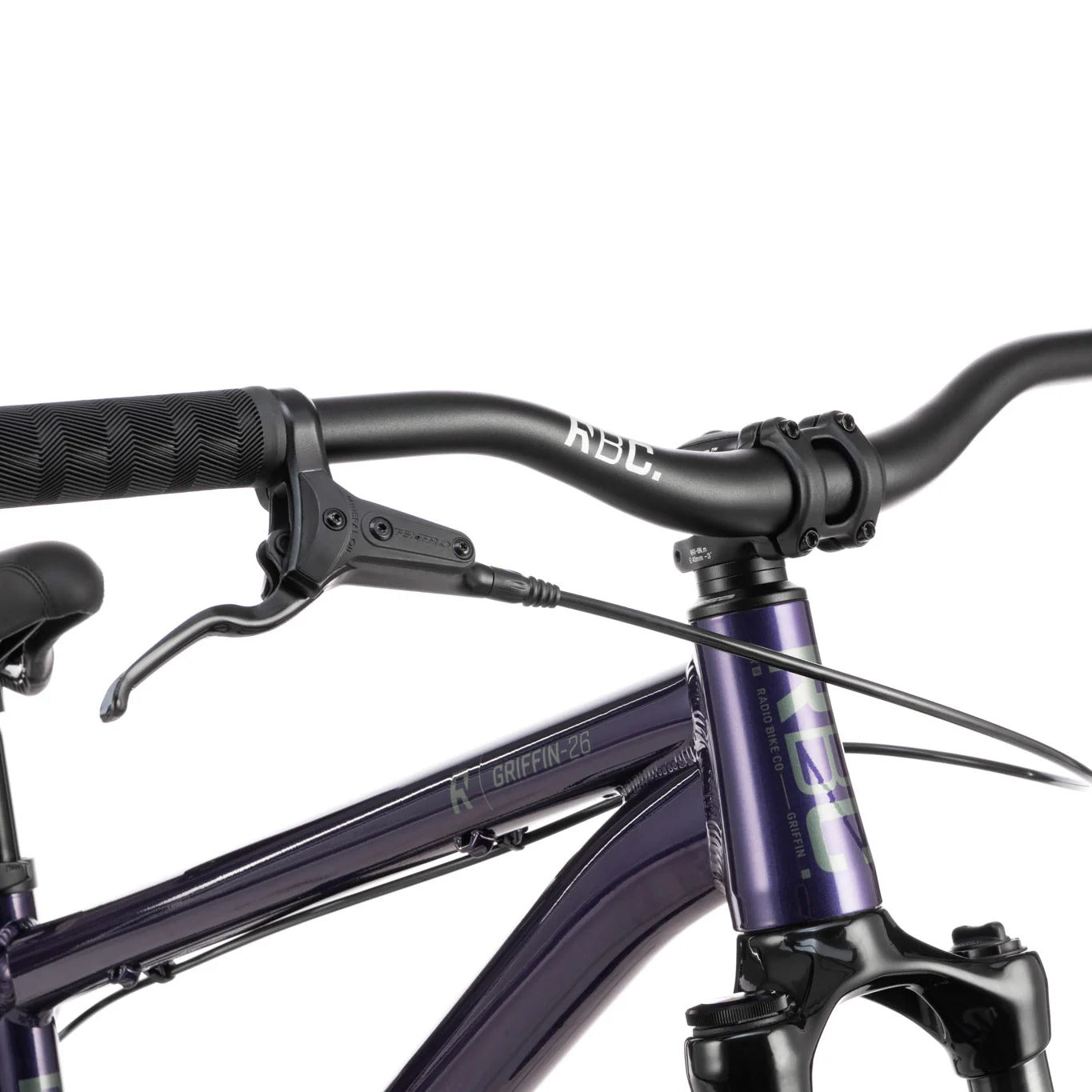 Close-up of a purple bicycle with black handlebars on a white background