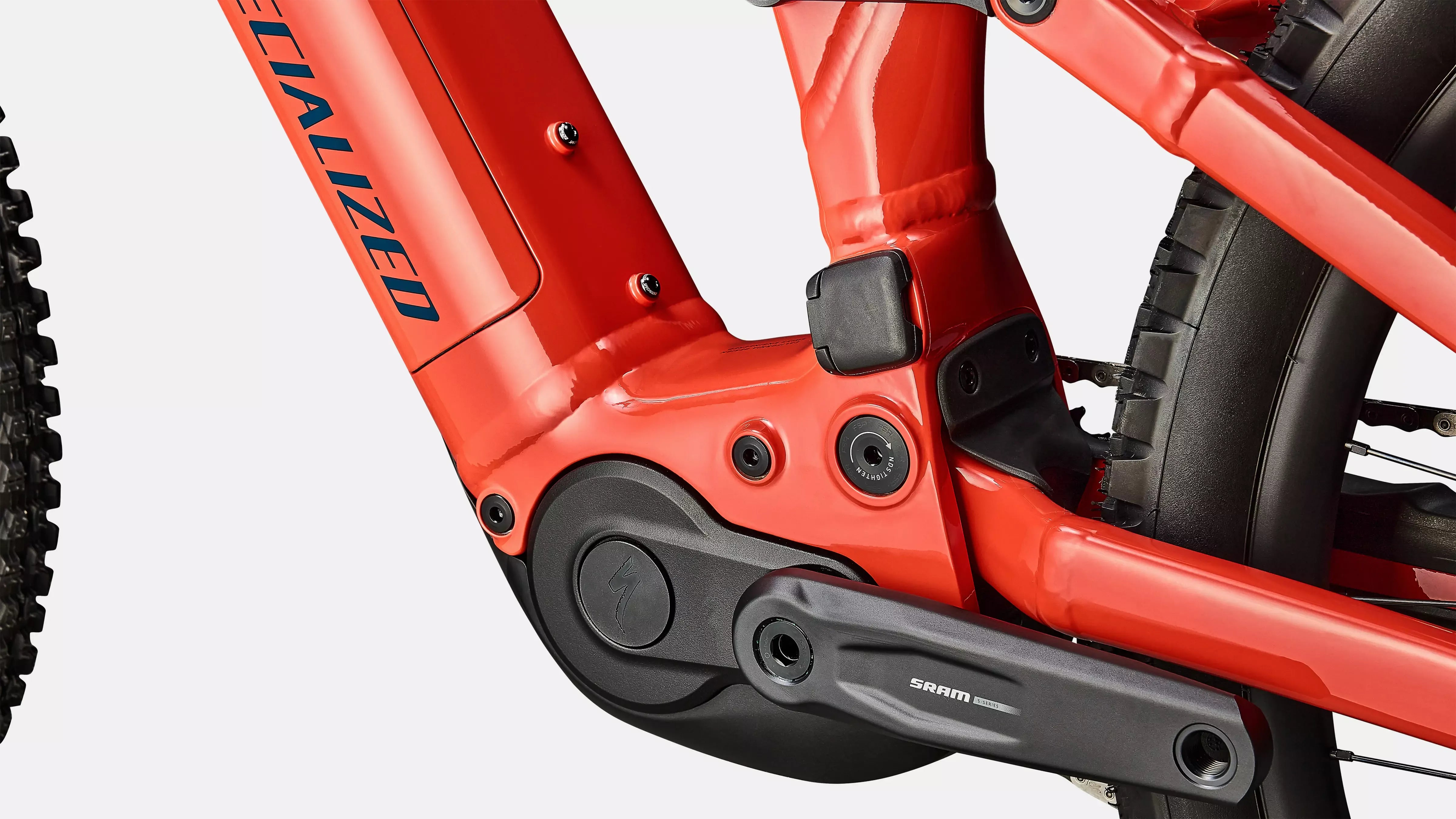 Close-up of a red electric bicycle frame with 'Specialized' branding on a white background