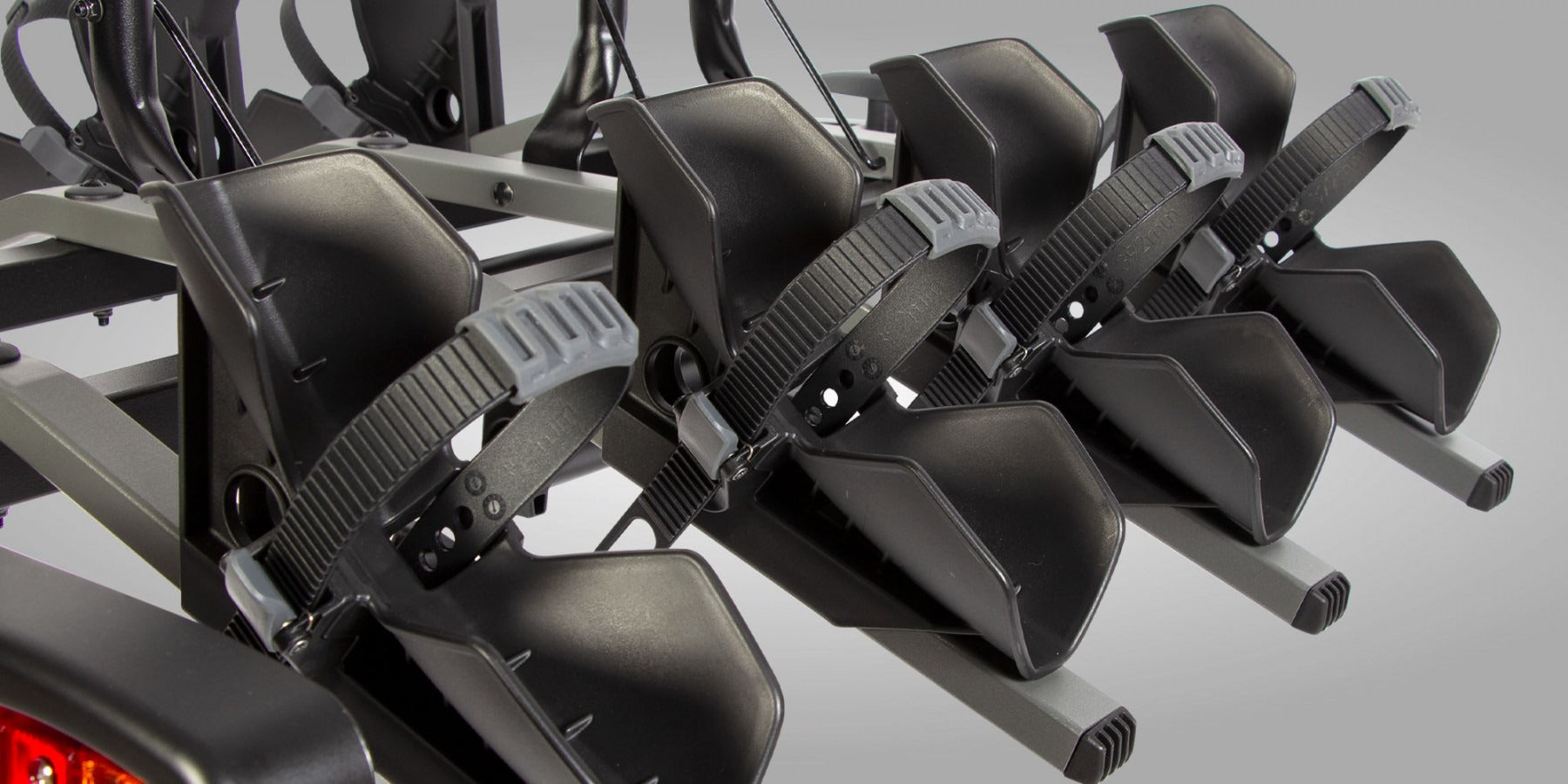 Close up of tyre straps on a bicycle rack on a gray background