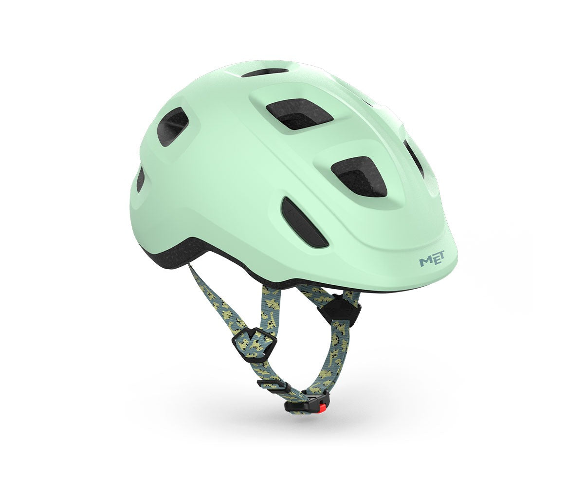 Mint green kids' helmet with dinosaur straps on a white background