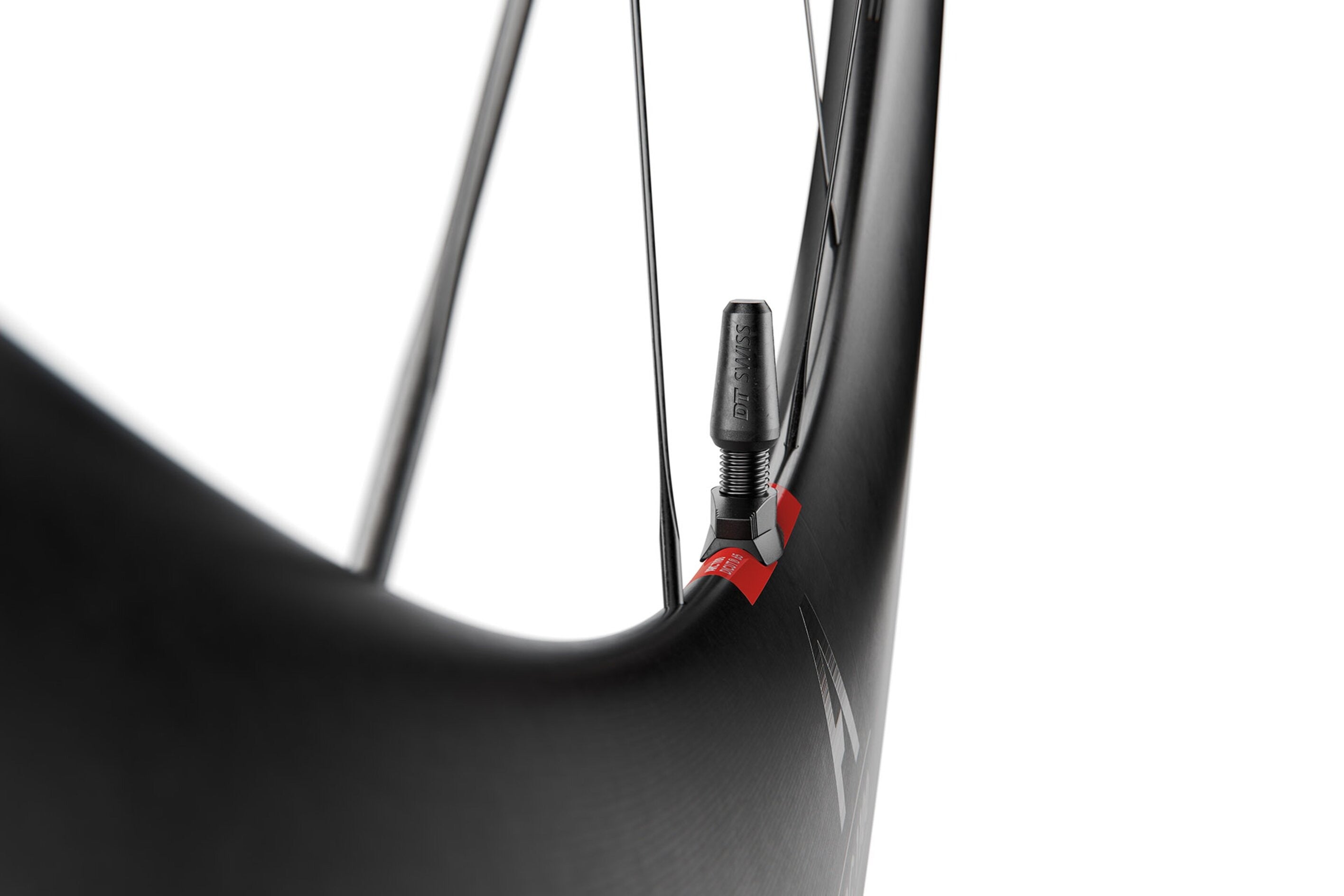 Close-up of a bicycle wheel with a red and black presta valve on a white background