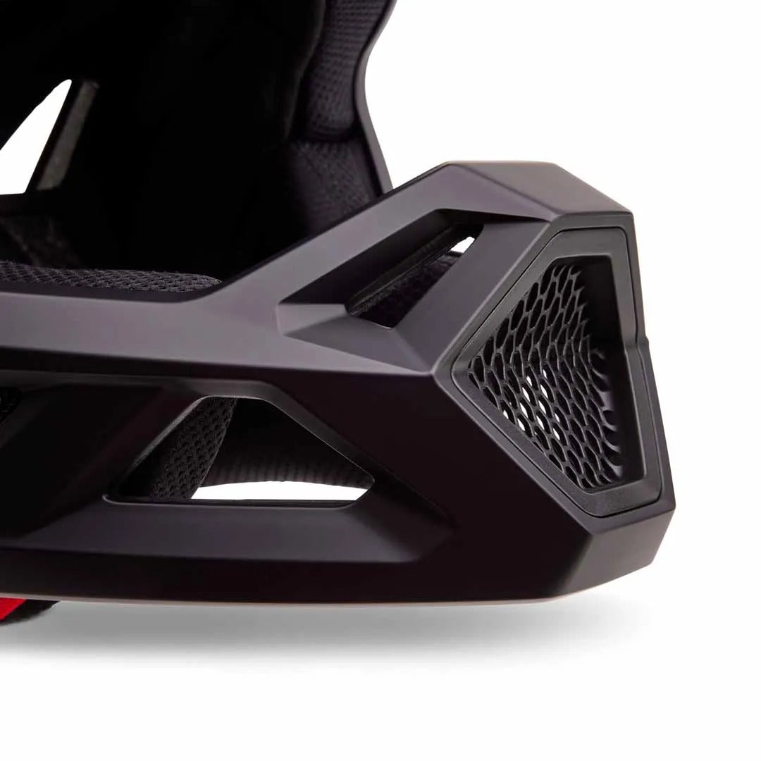 Close-up of the mouth guard on a black full face mountain bike helmet on a white background