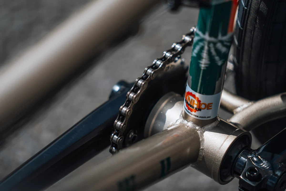 Close up of a BMX Bicycle chain on a white background