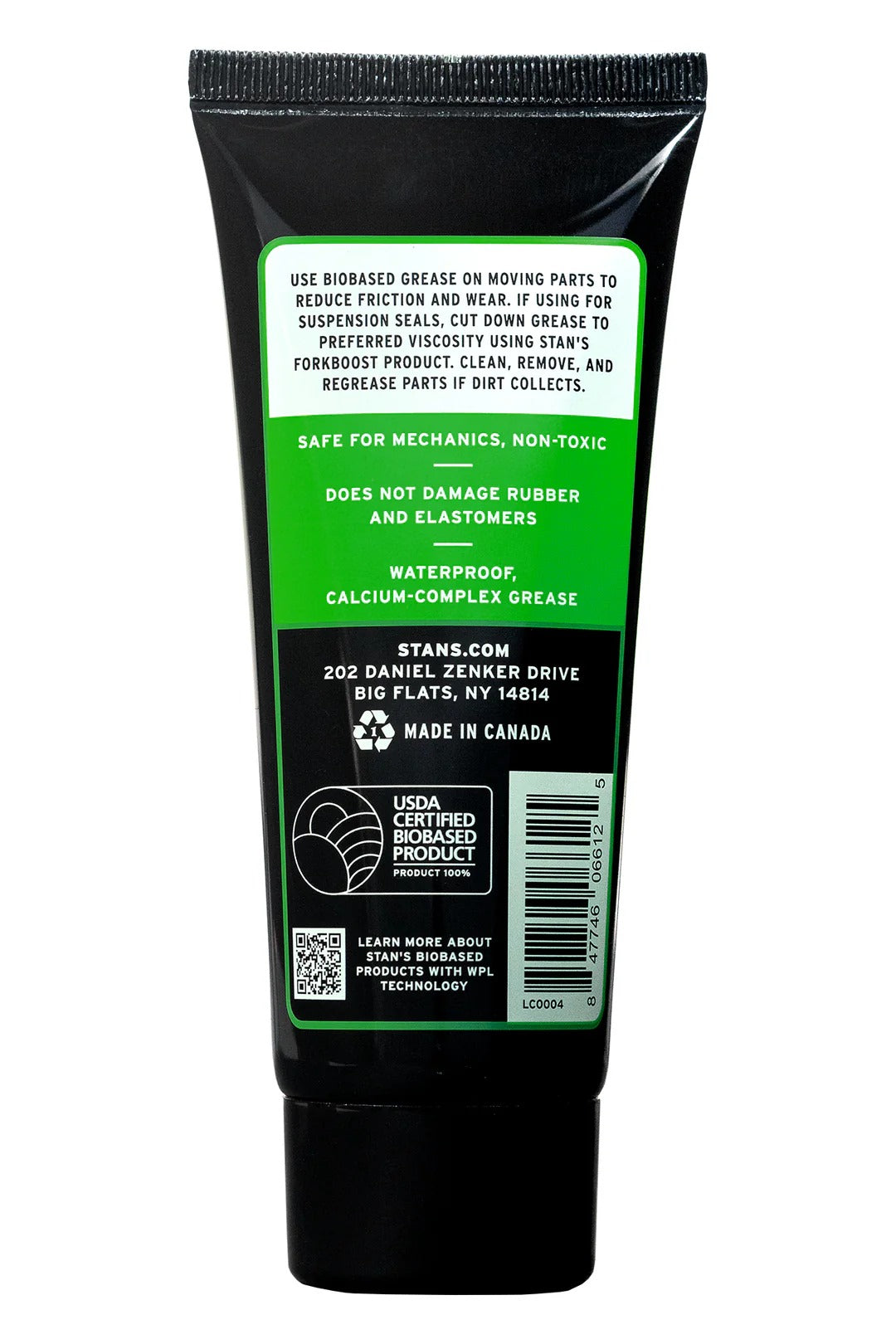 Green tube of grease with label on a white background