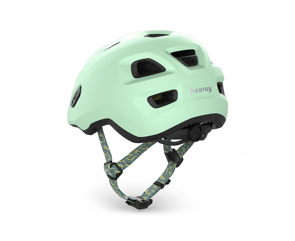 Mint green kids' helmet with dinosaur straps on a white background