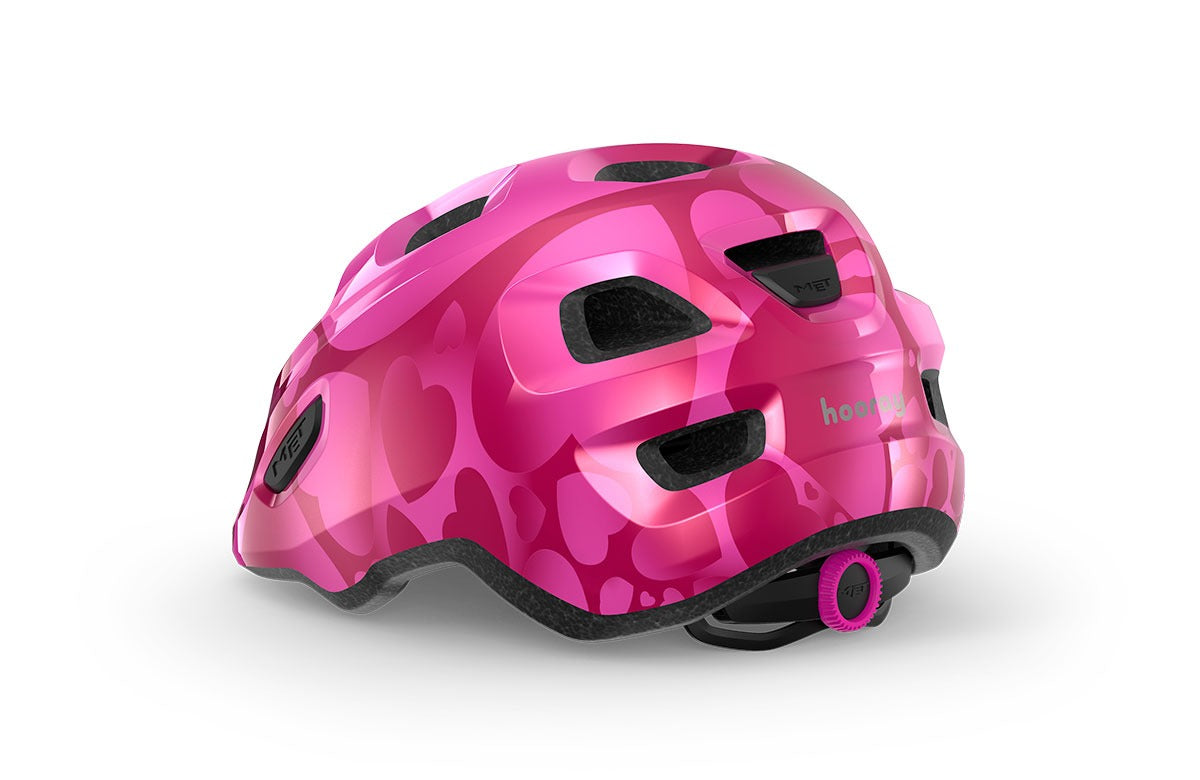 Pink kids' helmet withhearts on a white background