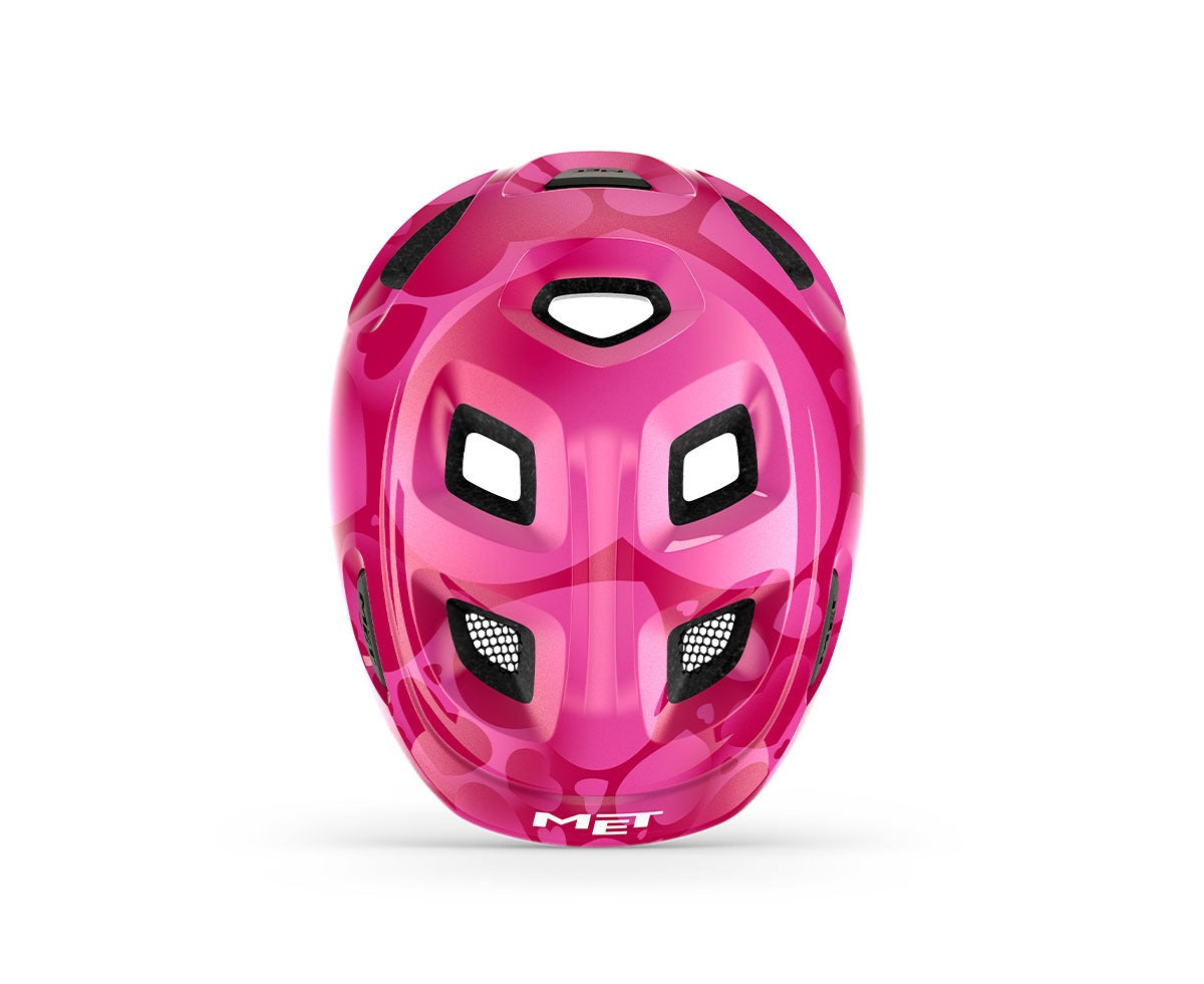Pink kids' helmet with hearts on a white background