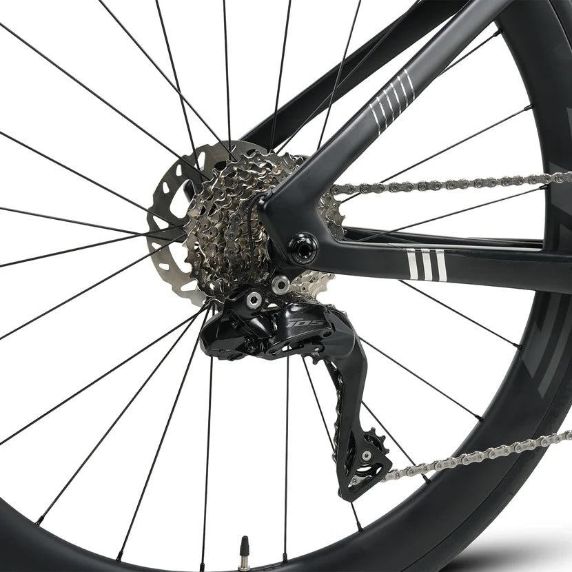 Close-up of a bicycle wheel with gear and chain on a white background