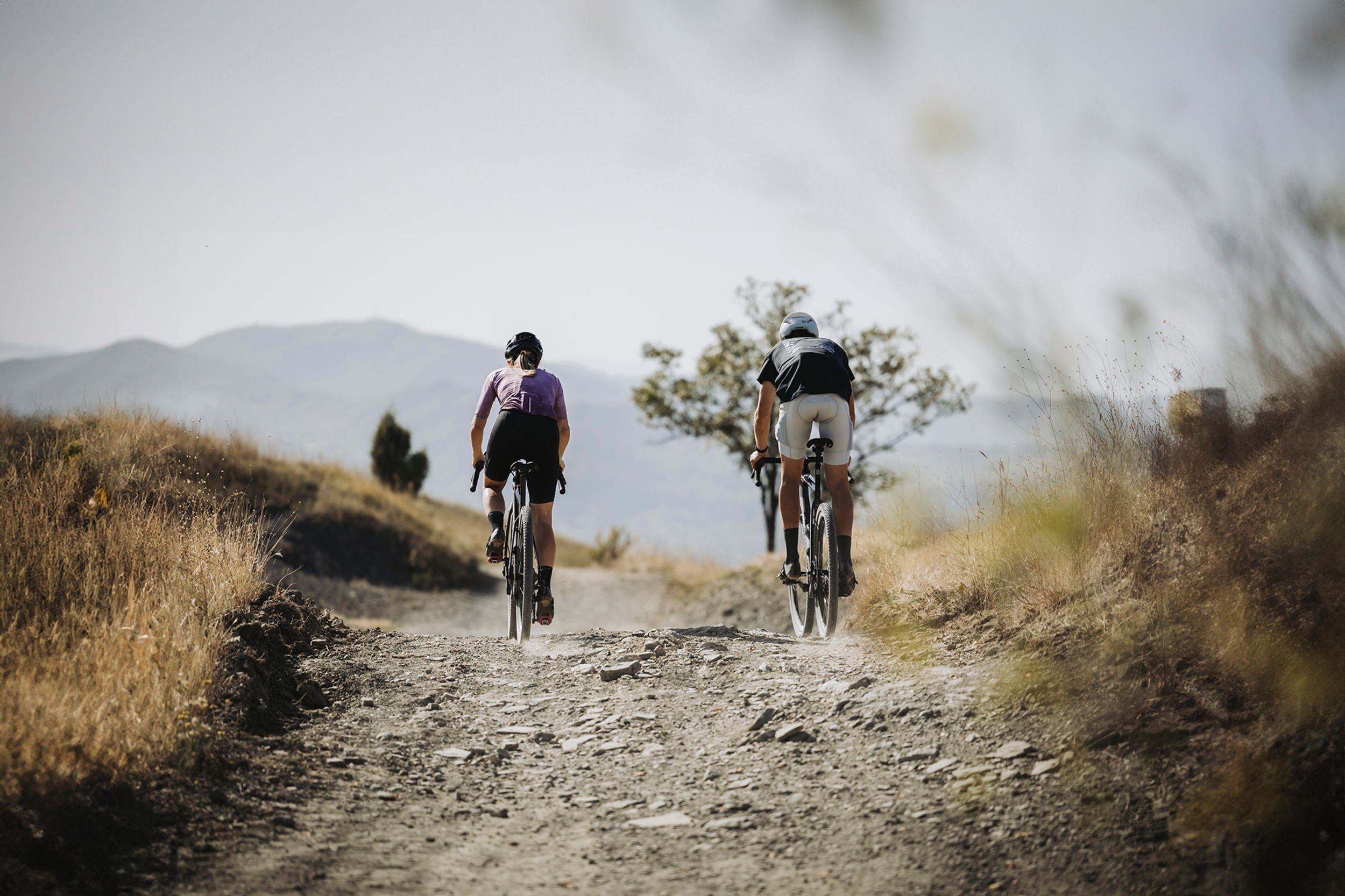 A picture of two cyclists riding gravel bikes