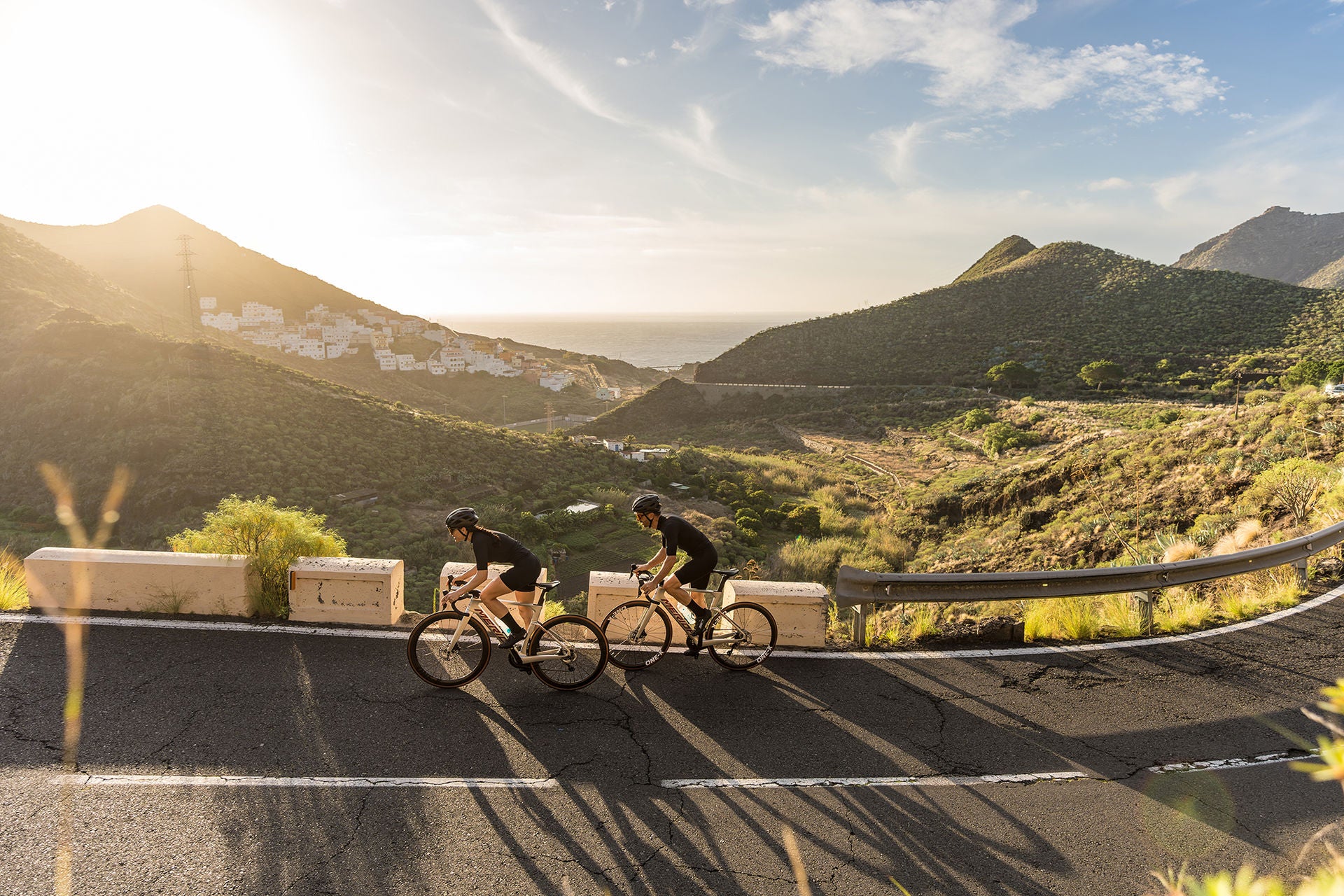 Two cycists riding uphill on Merida Road Bike