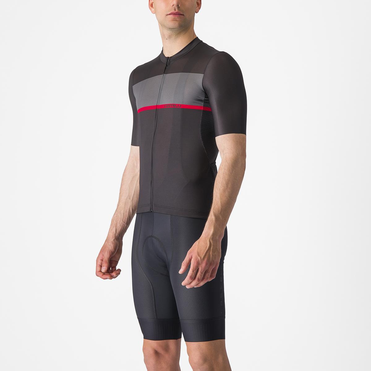 Person wearing a black cycling outfit with a red stripe on a white background