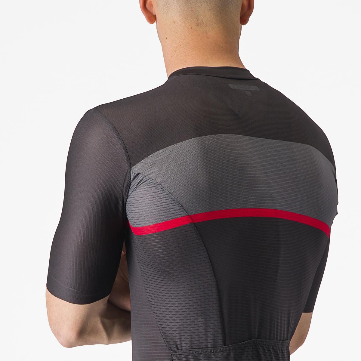 Person wearing a black and gray cycling jersey with a red stripe on a white background