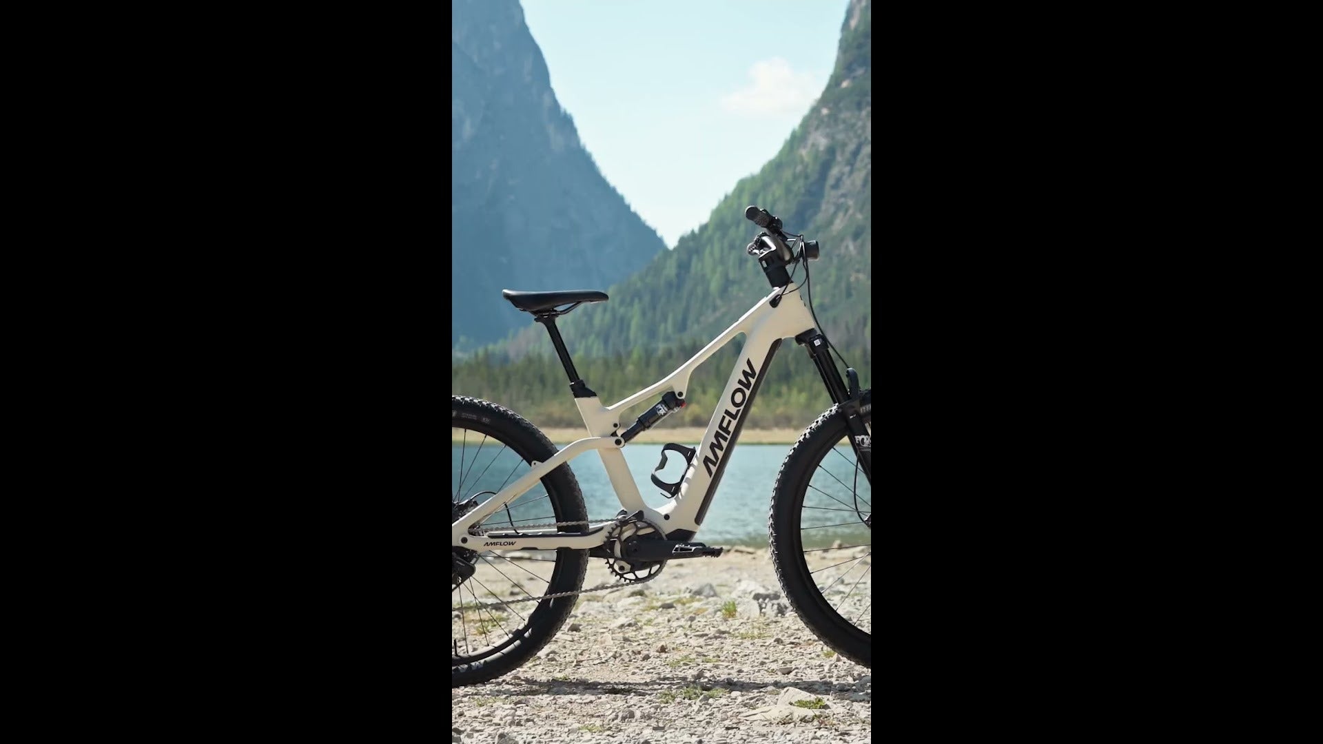 Dual Suspension AMFLOW Mountain bike against a mountainous landscape with a lake.