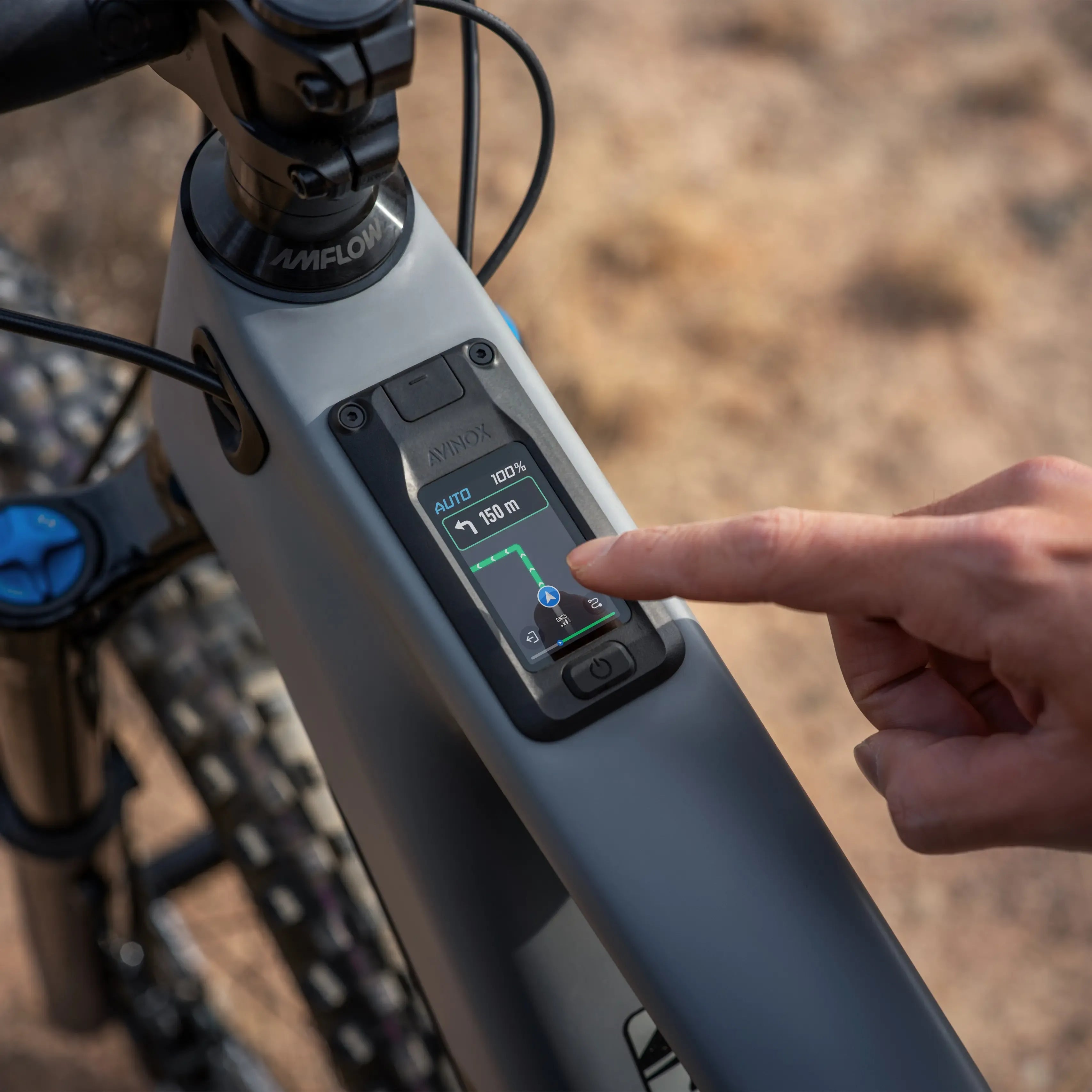 Person interacting with a digital display on an electric bike with a blurred natural background