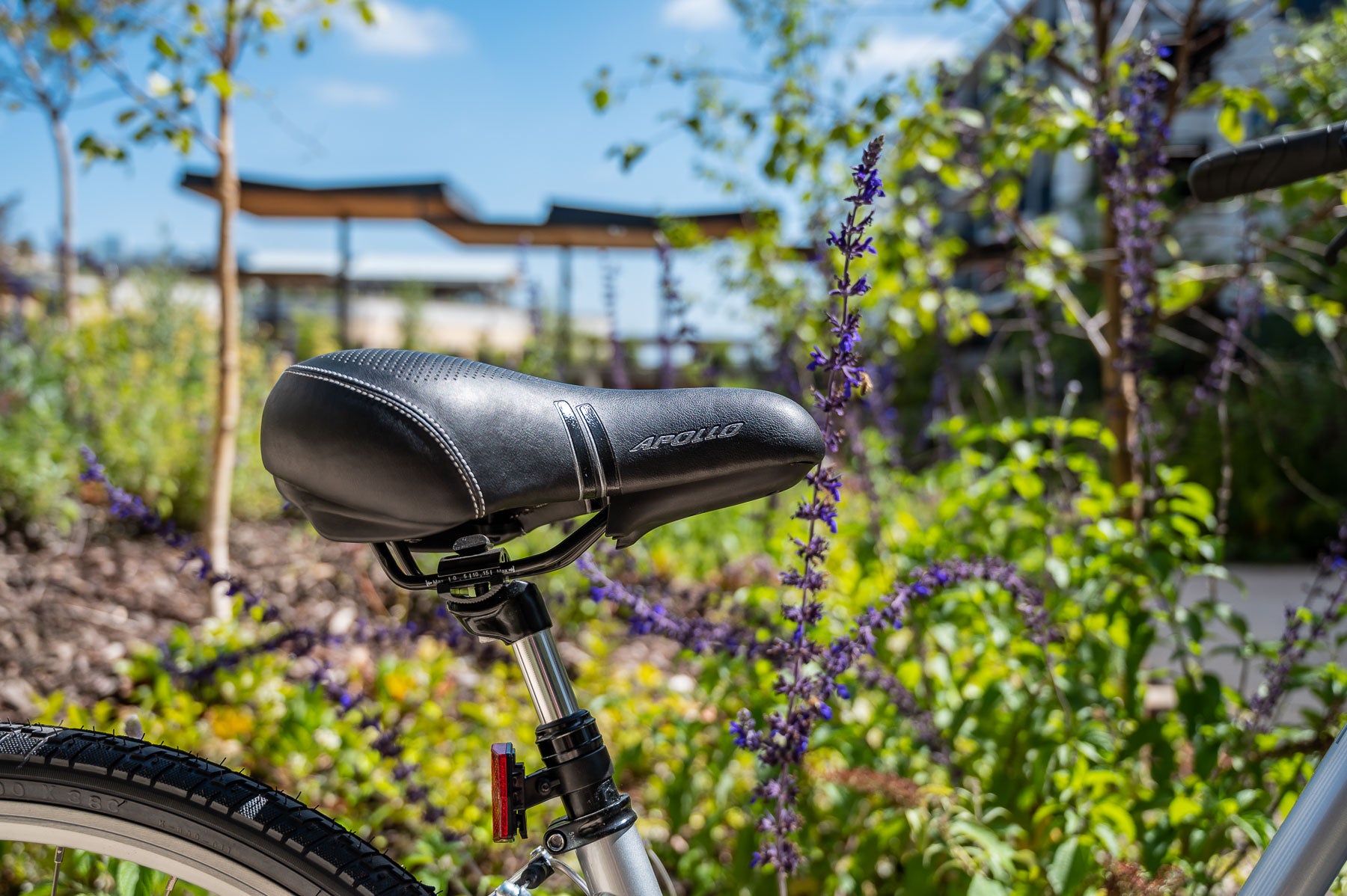 Bicycle seat with a scenic background of greenery and a gazebo.