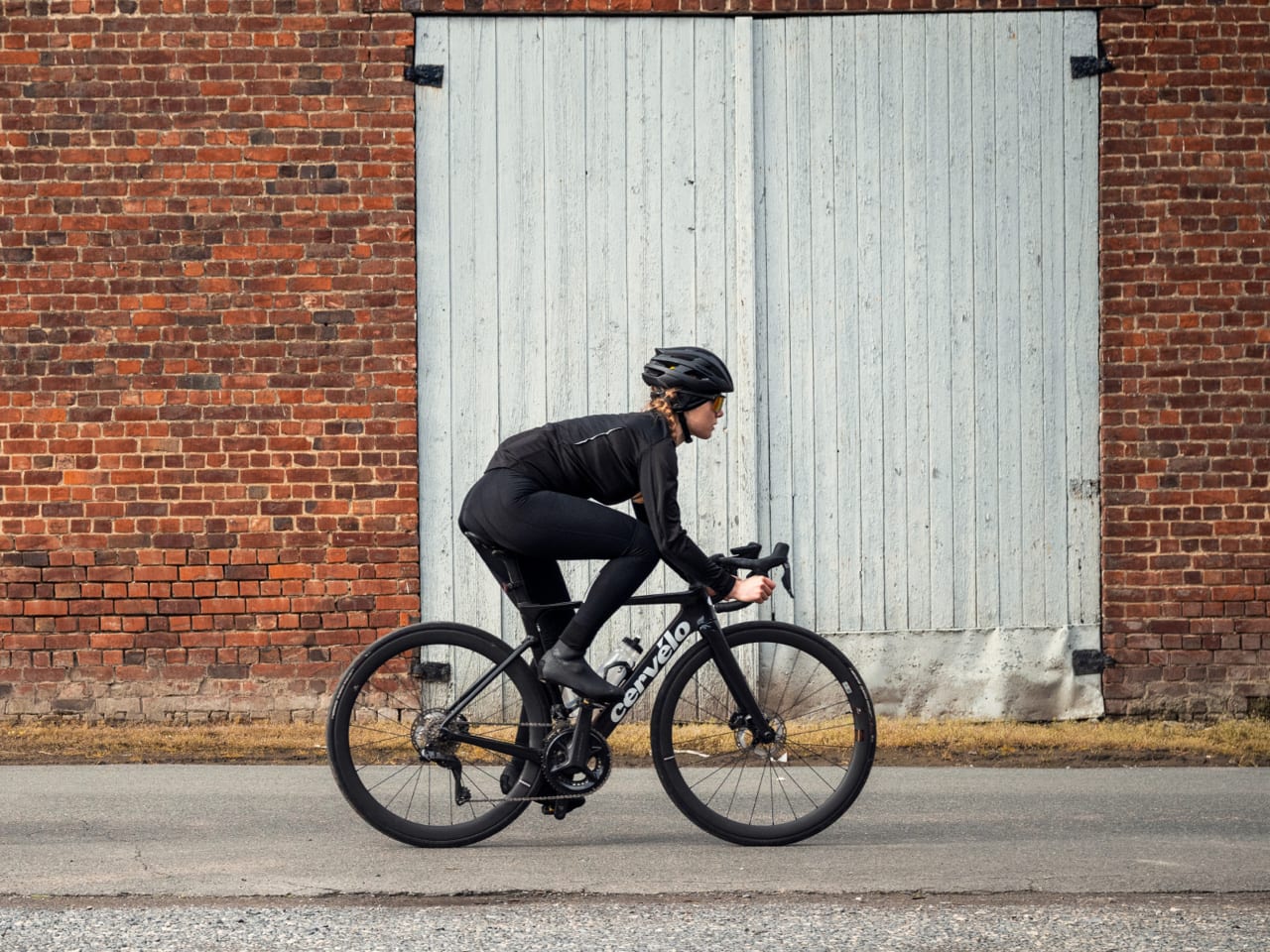 A lady riding a road bike wearing the BBB BBW-355 Womens Cycling Tights