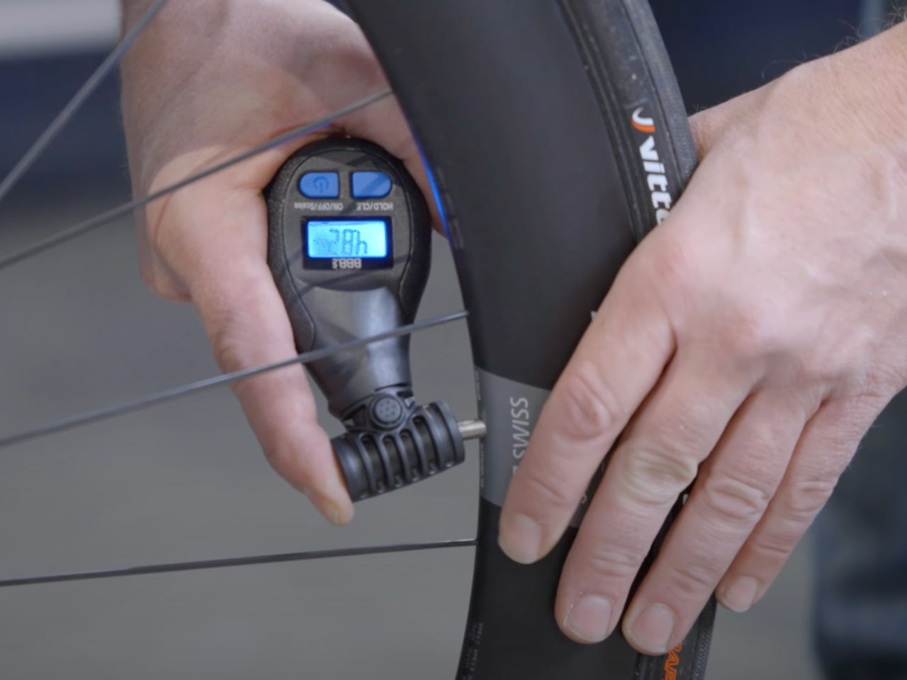 A picture of someone using the BBB BMP-92 Digital Pressure GadgetGauge tool on a tyre