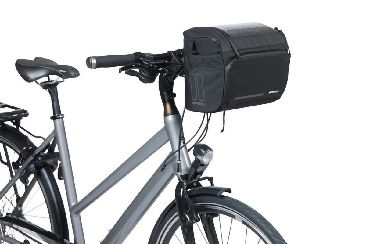 A silver bike with a black handlebar bag attached on a white background