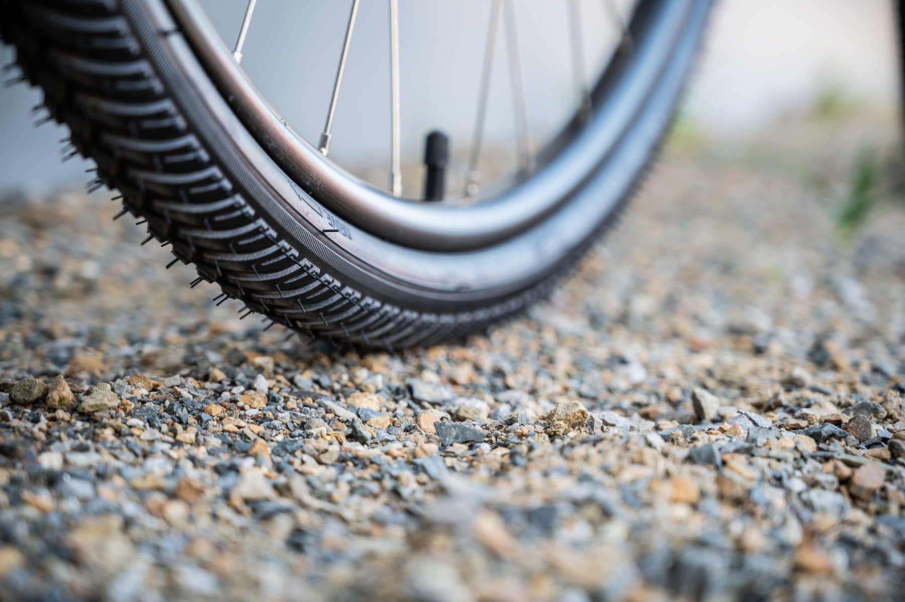 Close-up of a bicycle tyre on a gravel surface