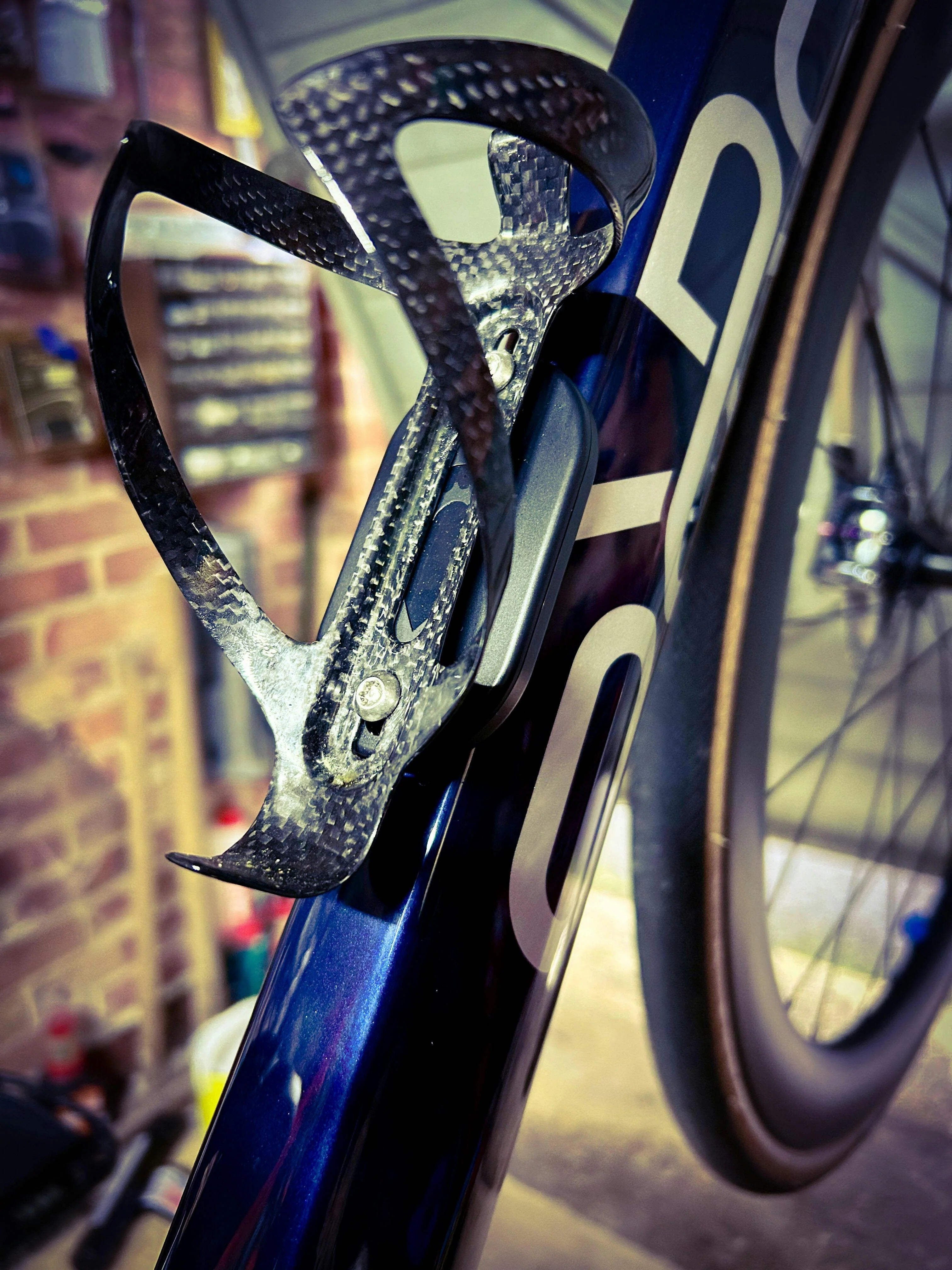 A picture showing the Bikebac Bike Tracker device under the bottle cage on a bike with a blurred background