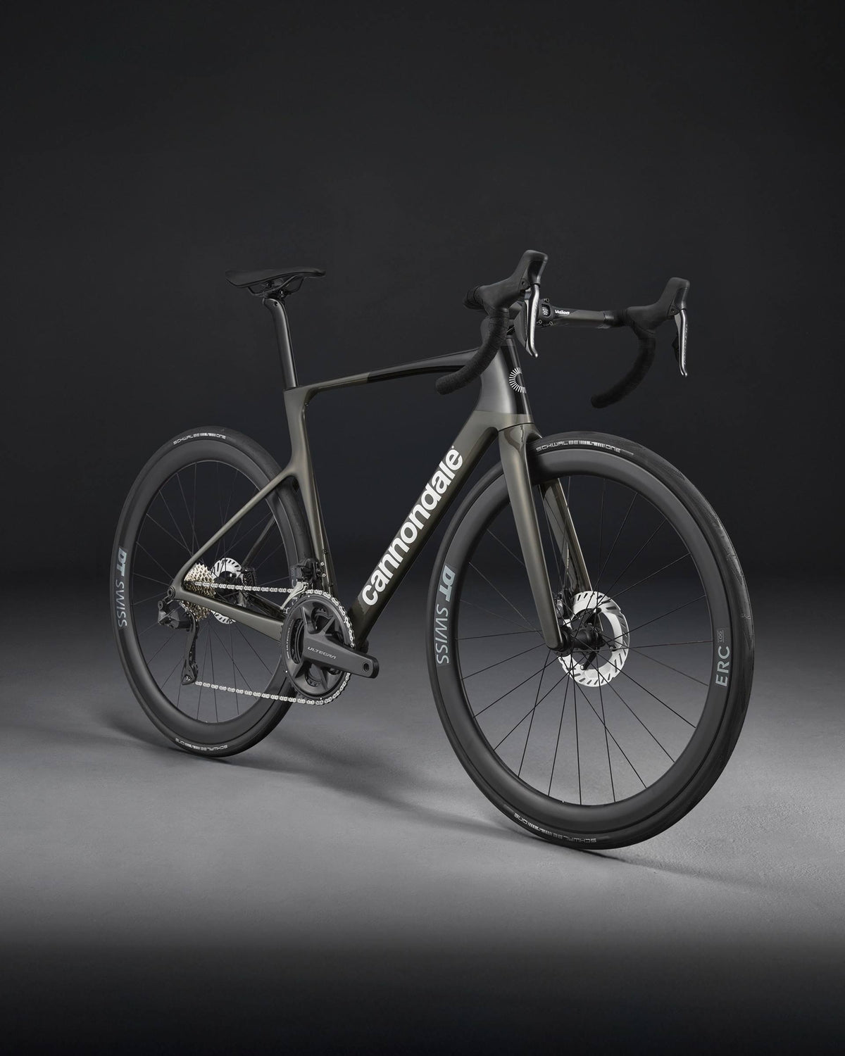 A charcoal Cannondale bicycle on a dark background